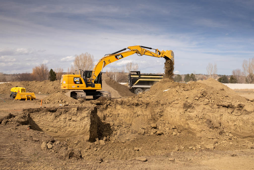 CAT excavator loading a dump truck on a Billings, Montana excavation site