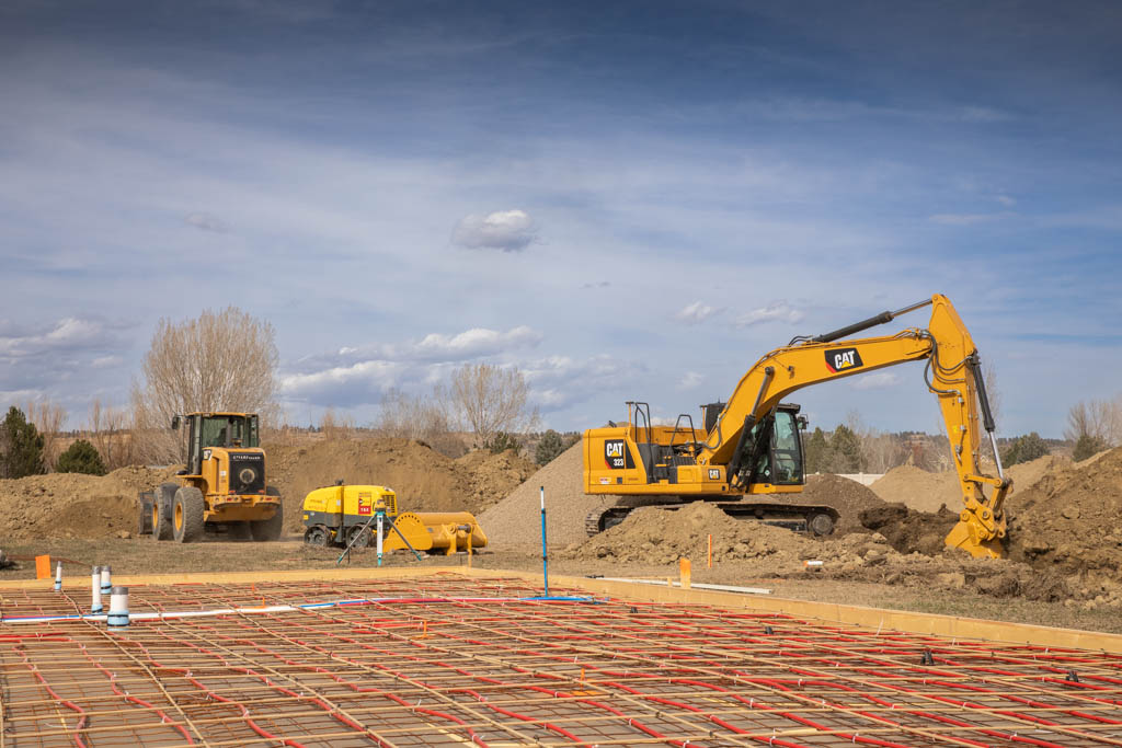 Excavator and wheel loader preparing a construction building site