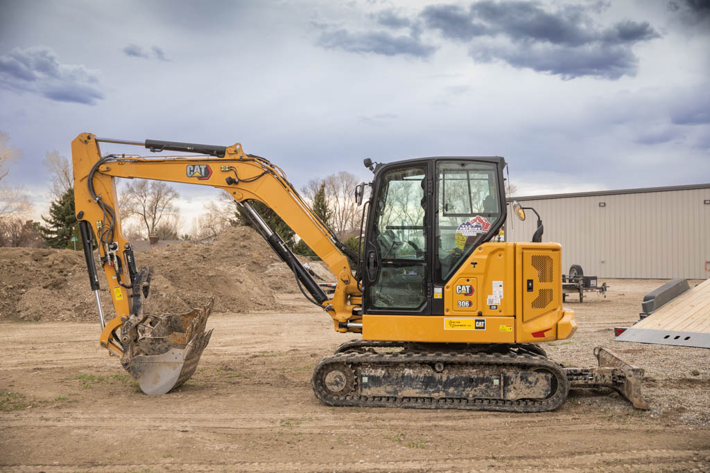 CAT 306 mini excavator used for septic inspection and maintenance work