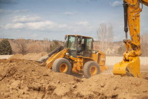 Loader operator for TLC Patriot Excavation preparing for a home foundation