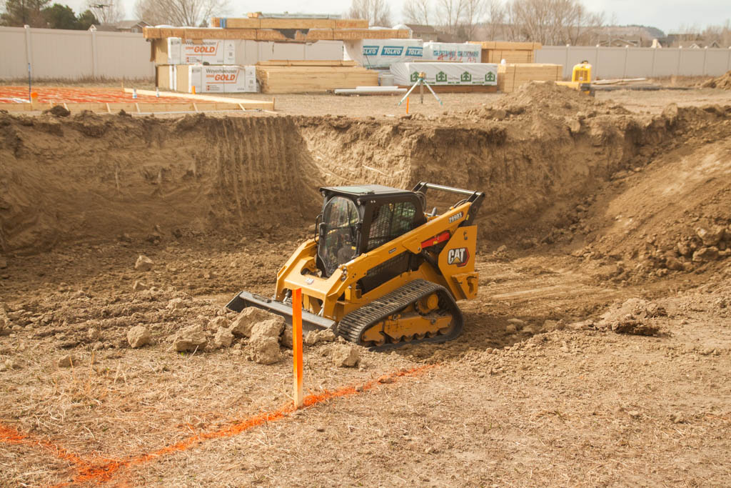 TLC Patriot Excavation skid steer doing construction site prep for a new home foundation