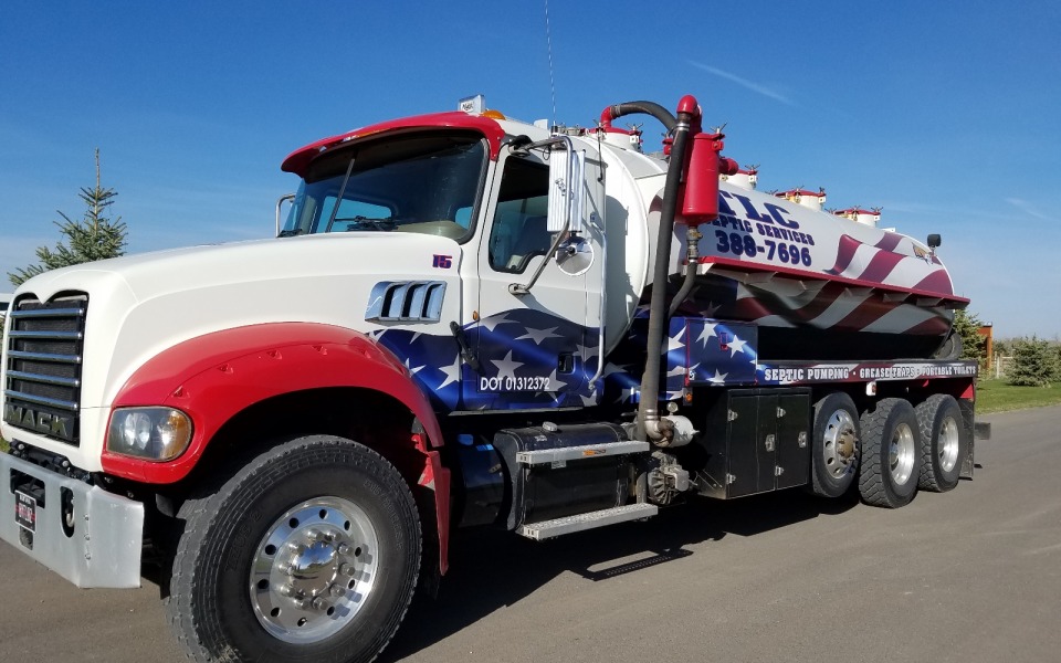 TLC Patriot Septic and Excavation in Billings MT. Septic pump truck with american flag across the side